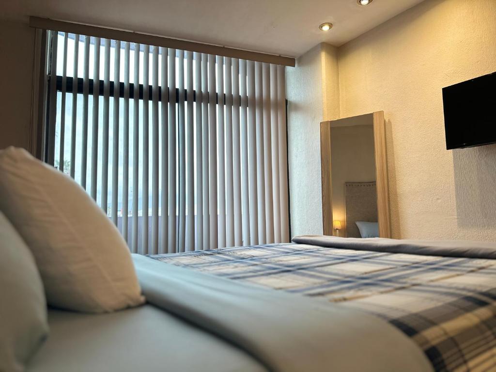 Postel nebo postele na pokoji v ubytování Hospedaje GGG
