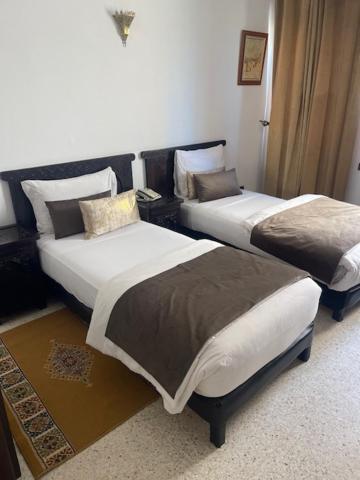 Postel nebo postele na pokoji v ubytování Hotel La Perle du Sud