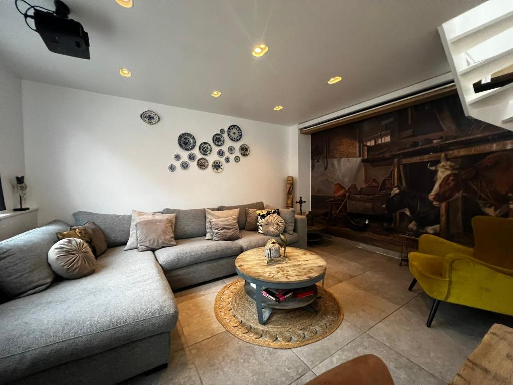 a living room with a couch and a fireplace at Luxury apartment in farmhouse near Amsterdam in Ilpendam