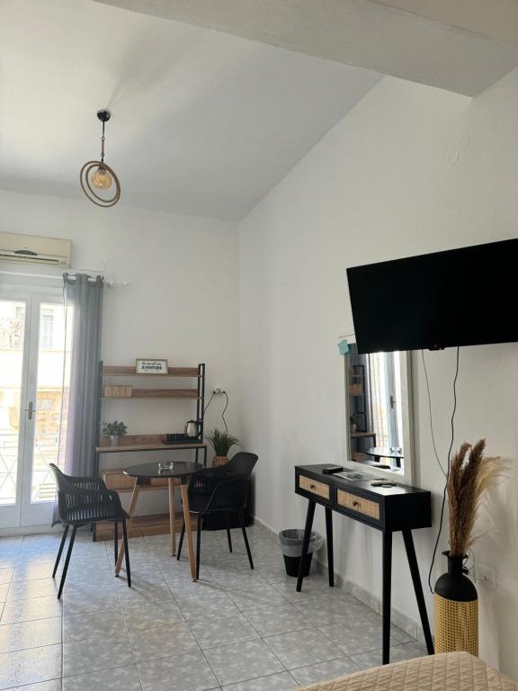 a living room with a piano and a table at BYZANTIUM APARTMENTS in Ermoupoli