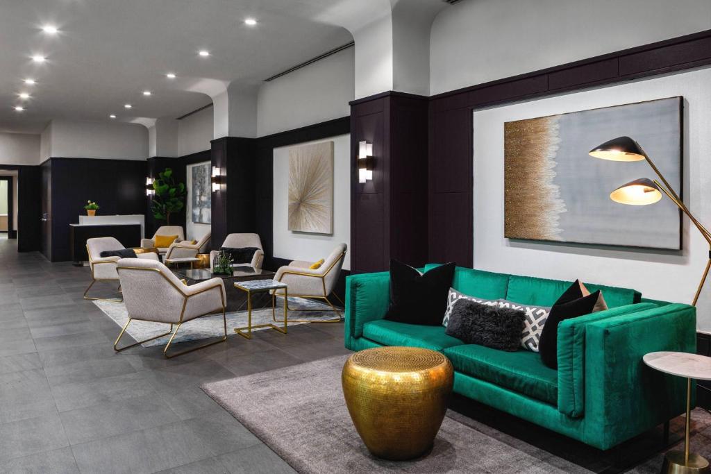 a living room with a green couch and chairs at Courtyard New York Manhattan/Times Square in New York