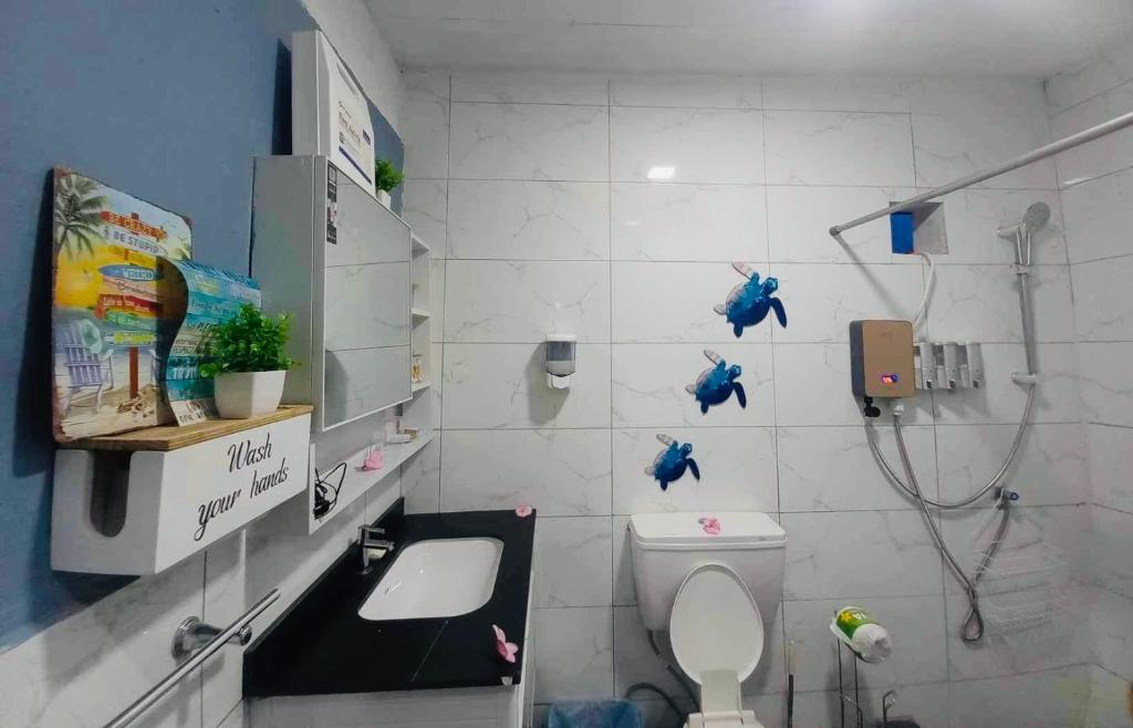 a white bathroom with a shower and a toilet at Sale’aula Lava Studio Apartment in Saleaula