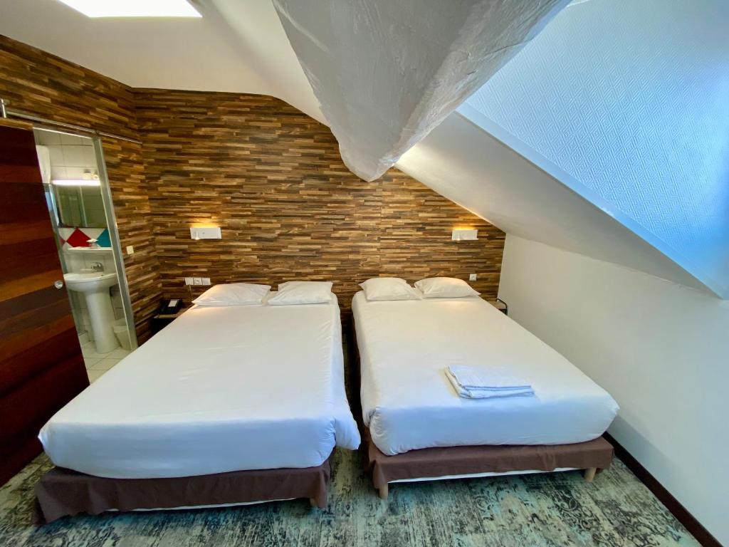 Postel nebo postele na pokoji v ubytování Hôtel du Helder