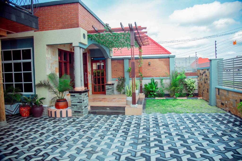 WILLOW INN في دودوما: منزل أمامه ساحة فناء