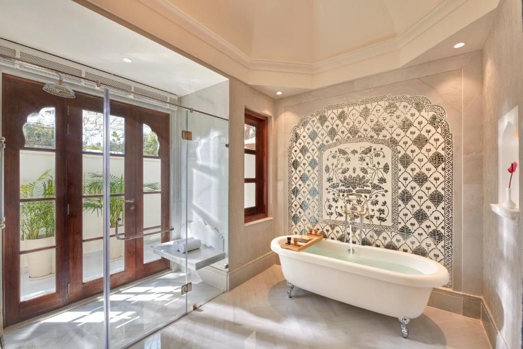a bathroom with a tub and a window at Mementos by ITC Hotels Jaipur in Jaipur