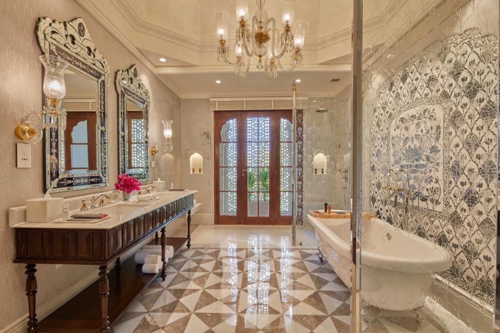 a bathroom with two sinks and a tub and a large mirror at Mementos by ITC Hotels Jaipur in Jaipur
