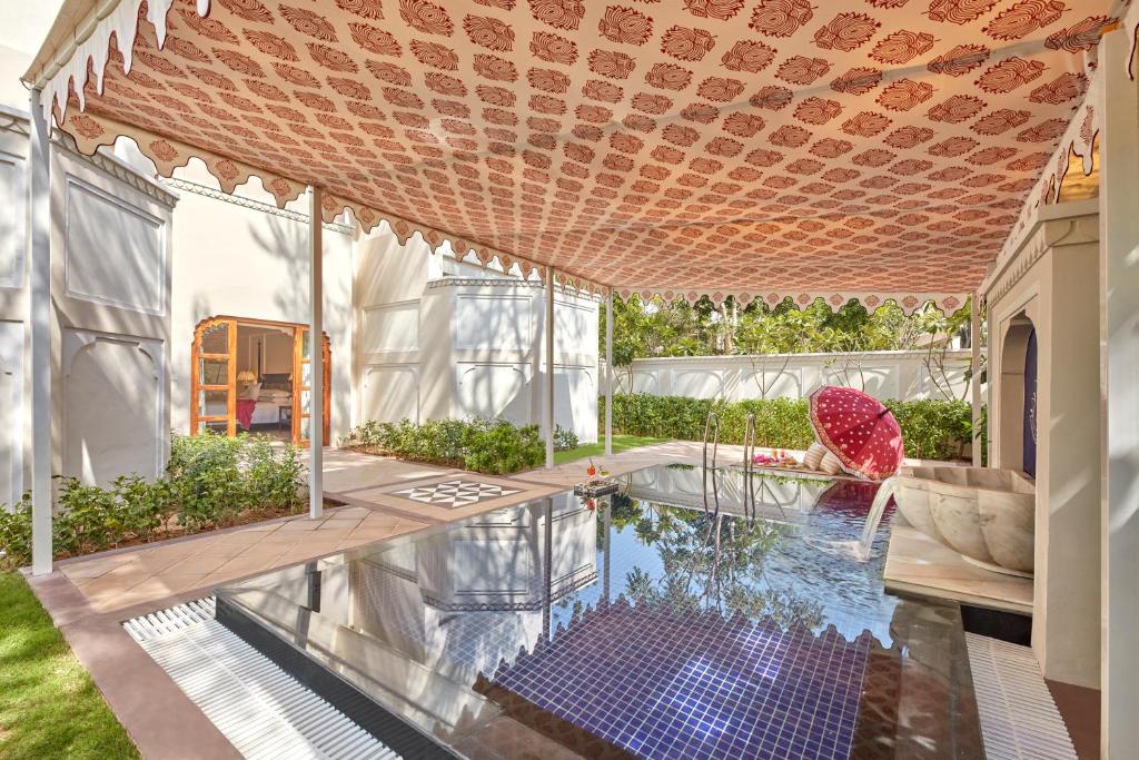 a house with a swimming pool and a patio at Mementos by ITC Hotels Jaipur in Jaipur