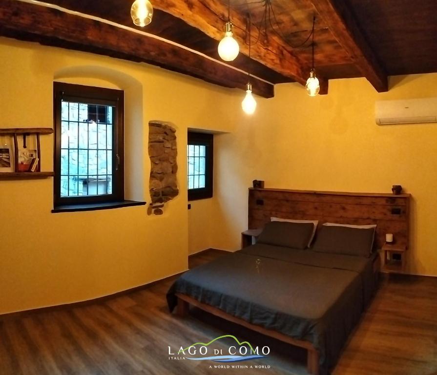 a bedroom with a bed in a room with yellow walls at La cascina della vigna del viandante in Abbadia Lariana