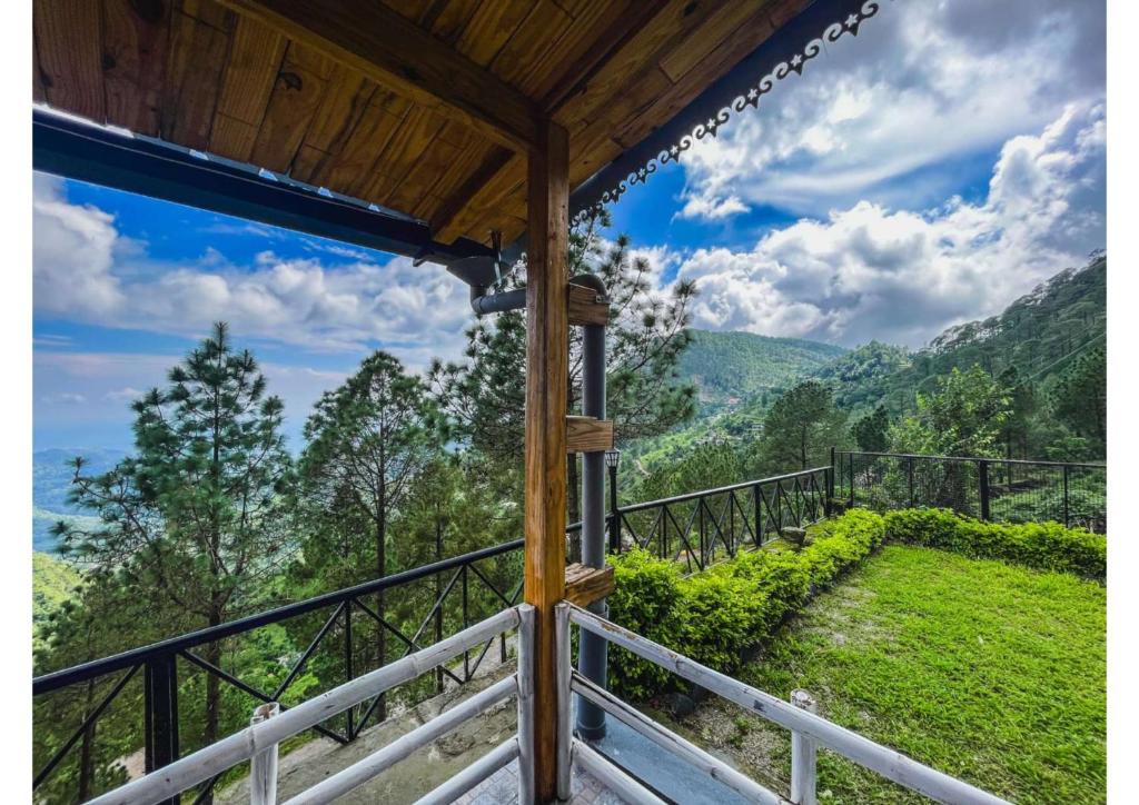 a view from the balcony of a mountain house at Stoneshed Resort And Hotel in Nainital