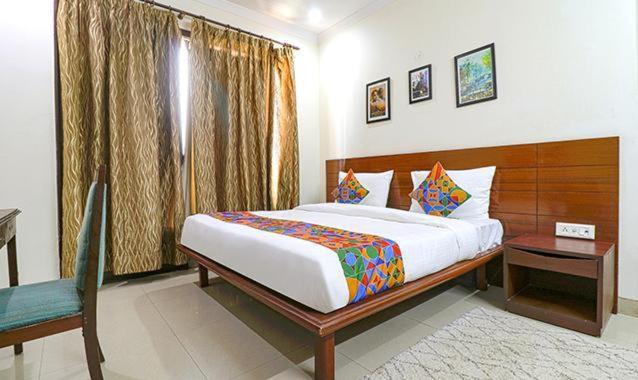 a bedroom with a large bed and a window at Tipsyy Inn Suites 020 in Gurgaon