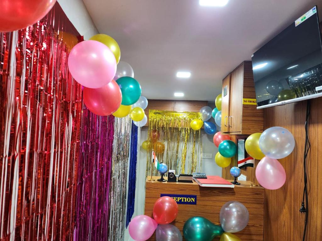 a bunch of balloons are attached to a wall at Kufa PG Dormitory in Mumbai