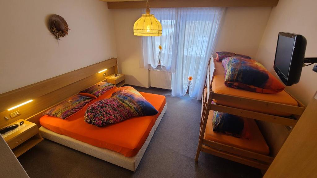 Postel nebo postele na pokoji v ubytování Hotel Garni Ongaro