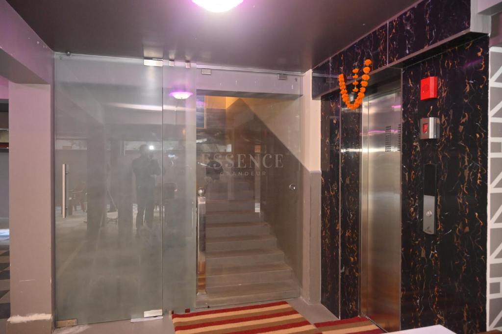 a glass hallway with a staircase in a building at ESSENCE GRANDEUR in Guwahati