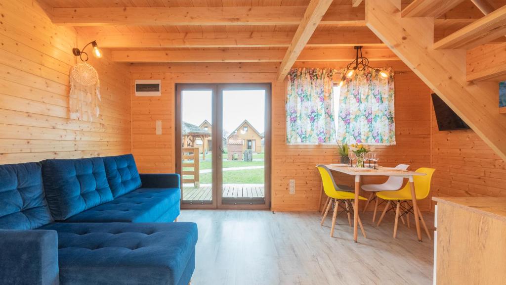 a living room with a blue couch and a table at Nowodworska, Sun & Snow in Stegna