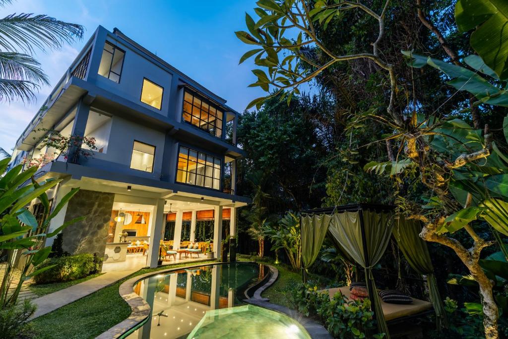 an exterior view of a house with a swimming pool at The Nani in Ubud
