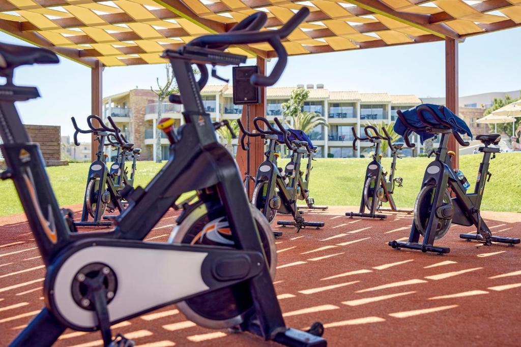 a row of exercise bikes parked under ailion at TUI Magic Life Candia Maris - Adults Only in Amoudara Herakliou