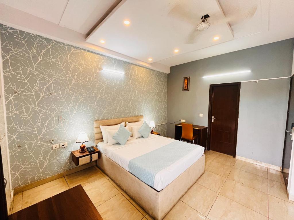 a bedroom with a large bed in a room at Comfort stay Noida sector 19 in Noida