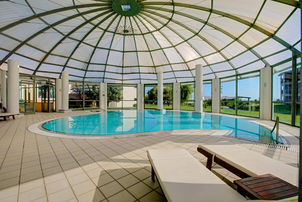 a large swimming pool with a domed roof at TUI Magic Life Candia Maris - Adults Only in Amoudara Herakliou