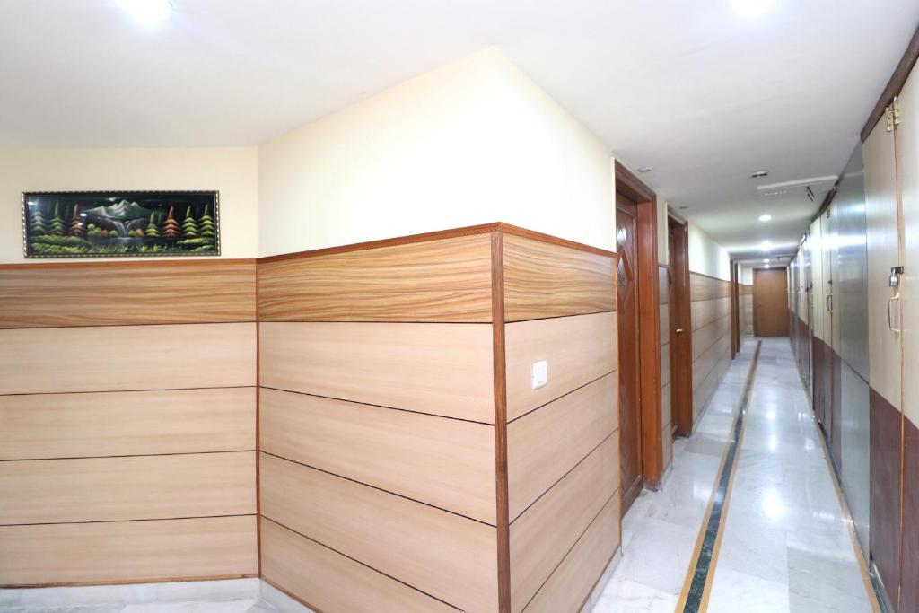 a walk in closet with wood paneling at OYO Flagship Vivek International Hotel in Jalandhar