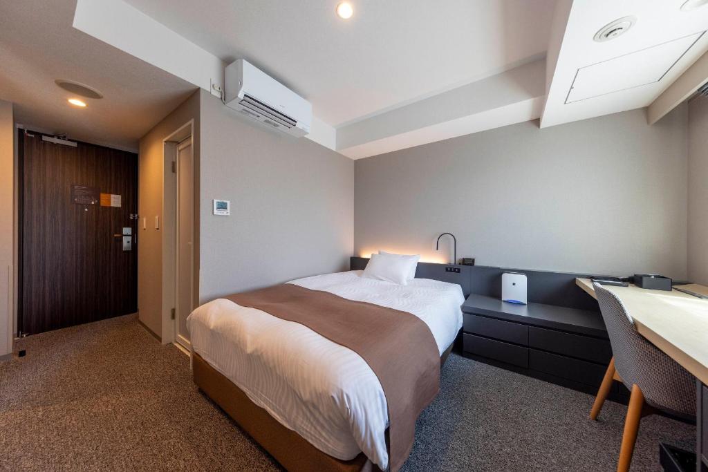 Postel nebo postele na pokoji v ubytování Hotel Granbinario Tsuruga