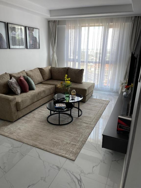a living room with a couch and a table at Fluted Nest 16th Floor Wood Avenue- Yaya centre Kilimani in Nairobi