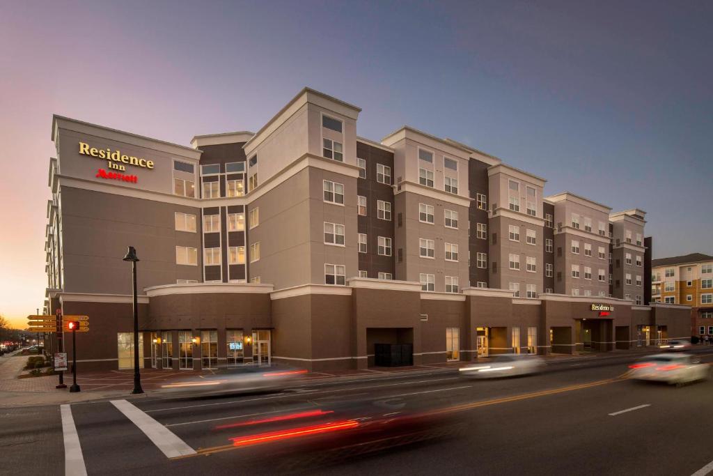 a building on a street with cars driving past it at Residence Inn by Marriott Tallahassee Universities at the Capitol in Tallahassee