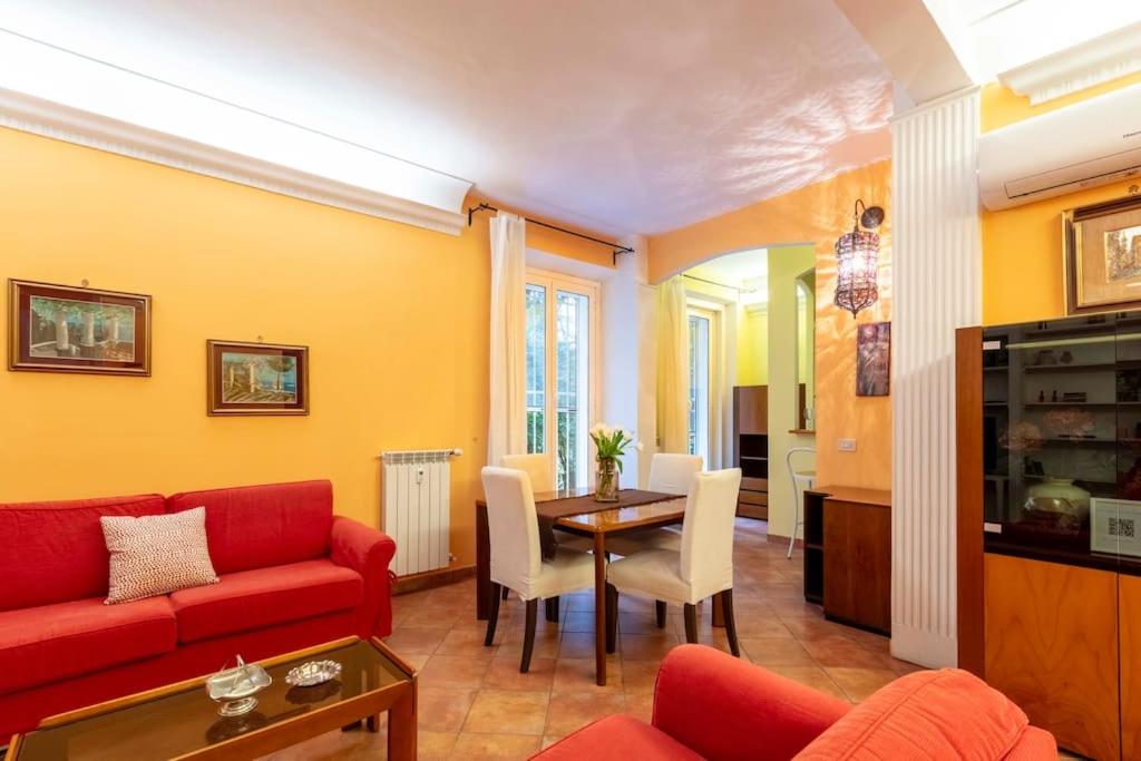 a living room with a red couch and a table at Casa Rio in Rome