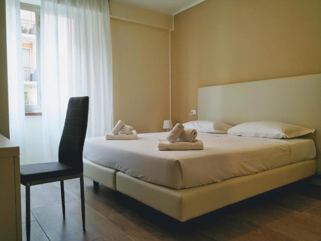 a bedroom with a bed with two towels on it at Verona Enjoy in Verona