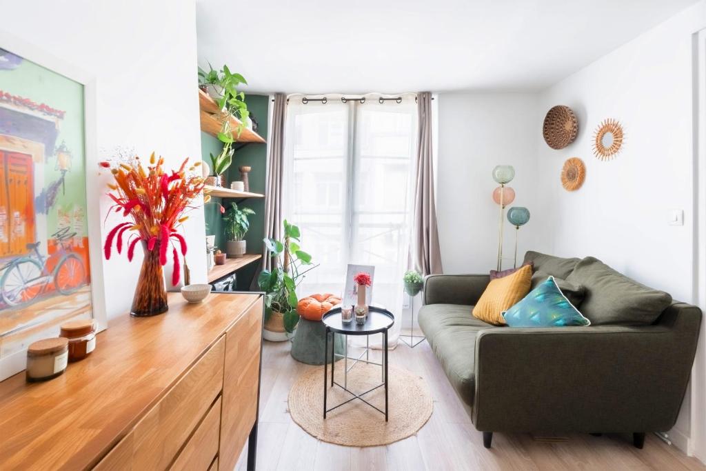 a living room with a couch and a table at Bright colorful apartment in the heart of Paris - Welkeys in Paris