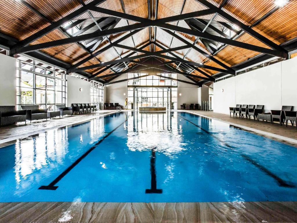 a large swimming pool with blue water at Fairmont Resort & Spa Blue Mountains MGallery by Sofitel in Leura