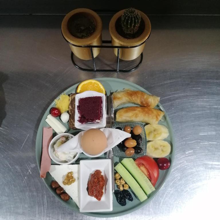 a plate of breakfast foods on a table at Hikmethan Otel in Kusadası