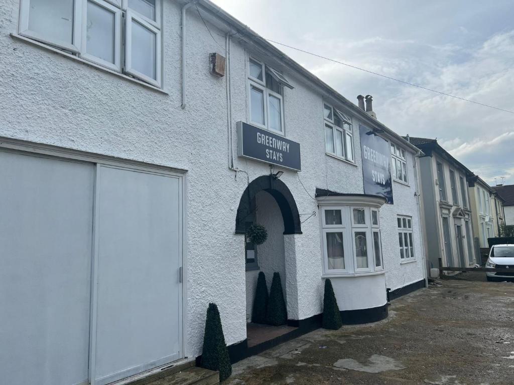 a white building with a sign that reads external sales at OYO Greenway Stays in Uxbridge