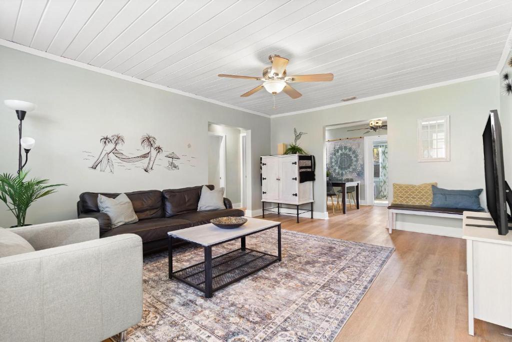 a living room with a couch and a ceiling fan at Relaxing Bungalow Walkable to the Beach! in St Pete Beach