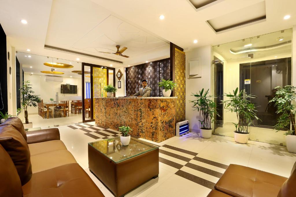a living room with a couch and a table at Denver Paragon Suites Delhi Airport in New Delhi