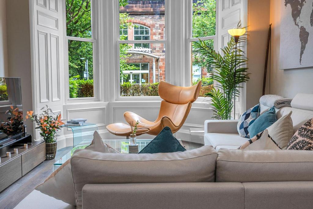 a living room with a couch and a chair at Stylish Elegance in City's Heart in Edinburgh