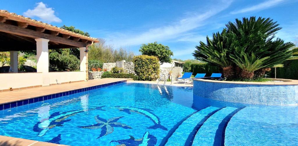 a swimming pool in a villa with a resort at Increible finca rustica con piscina in Selva