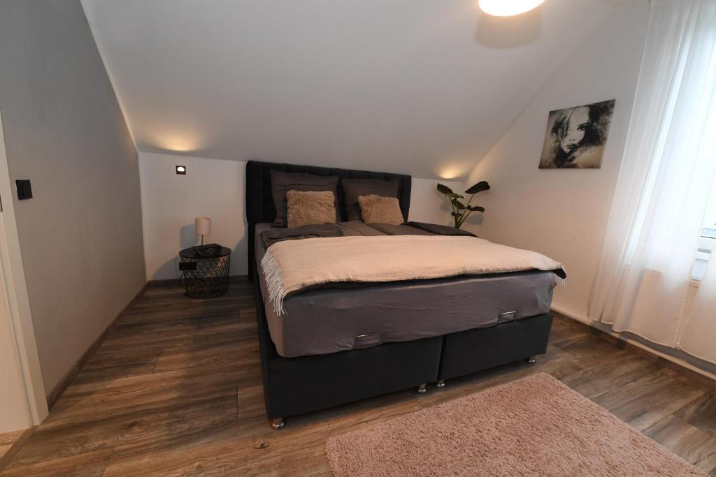 a bedroom with a large bed in a attic at Apartment Am Stadtwald in Werne an der Lippe / NRW in Werne an der Lippe