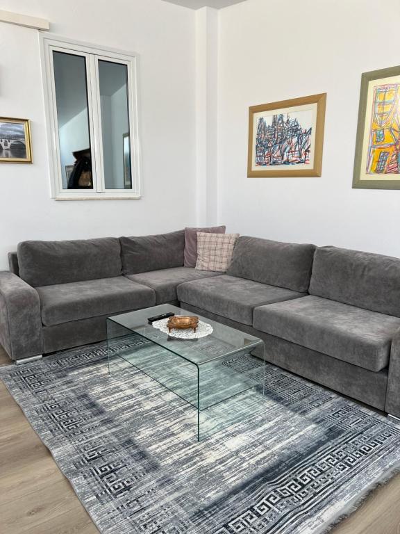 a living room with a couch and a glass table at Apartment Virginia in Berat