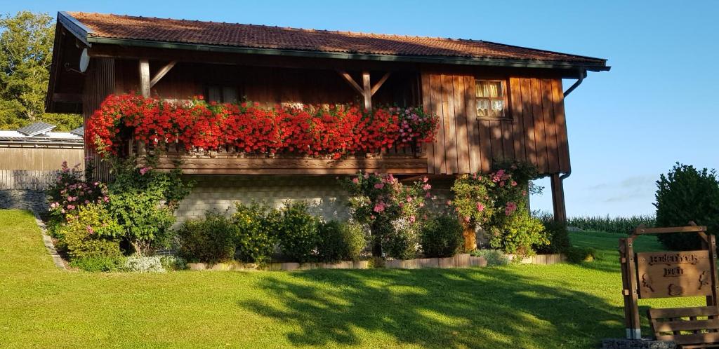 a house with flowers on the side of it at Ferienhaus Breit in Eppenschlag