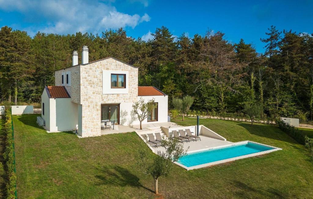 an external view of a house with a swimming pool at Villa-Venus in Višnjan