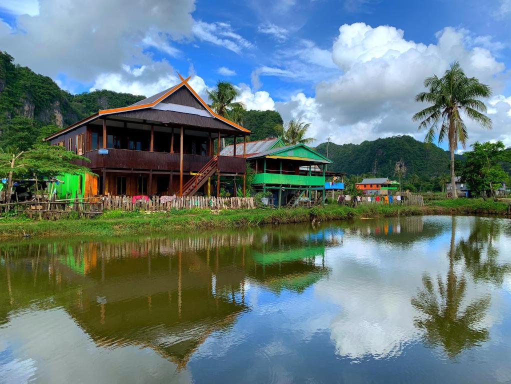 a house next to a body of water at NASRUL HOUSE HOMESTAY FOR BACKPACKERS in Maros