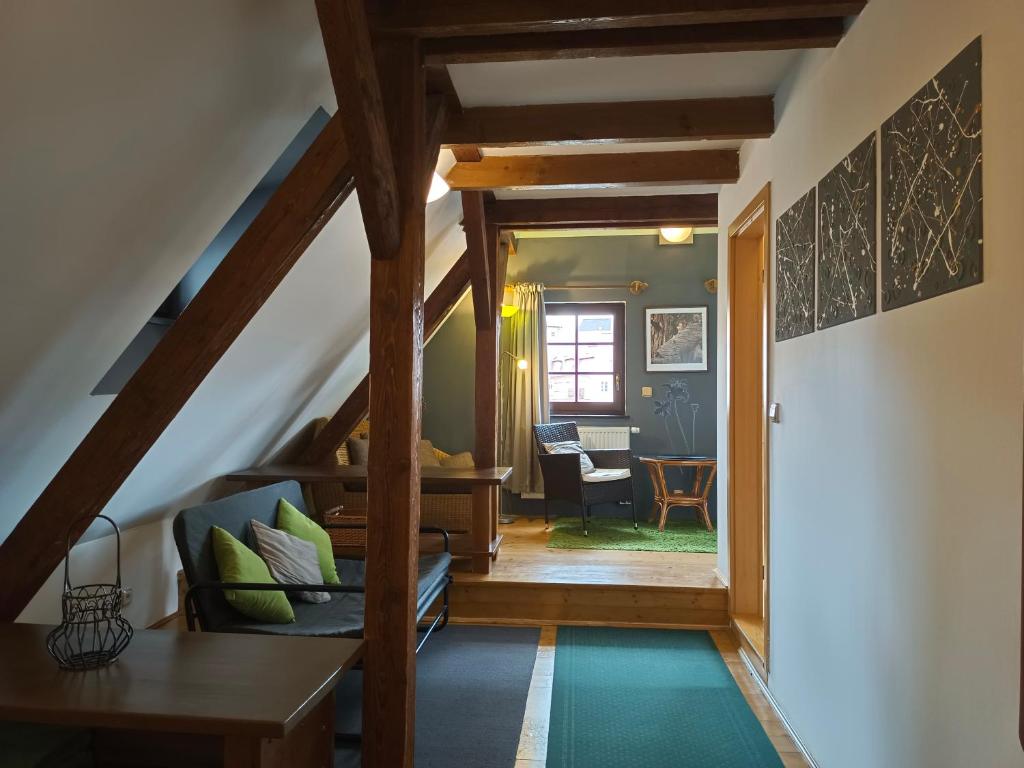 an attic hallway with a staircase and a living room at Guest House Olšakovský in Český Krumlov