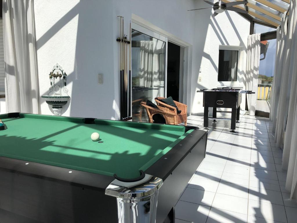 a pool table on the balcony of a house at Ferienwohnung Am Kreuzberg für 8 Personen in Medlingen