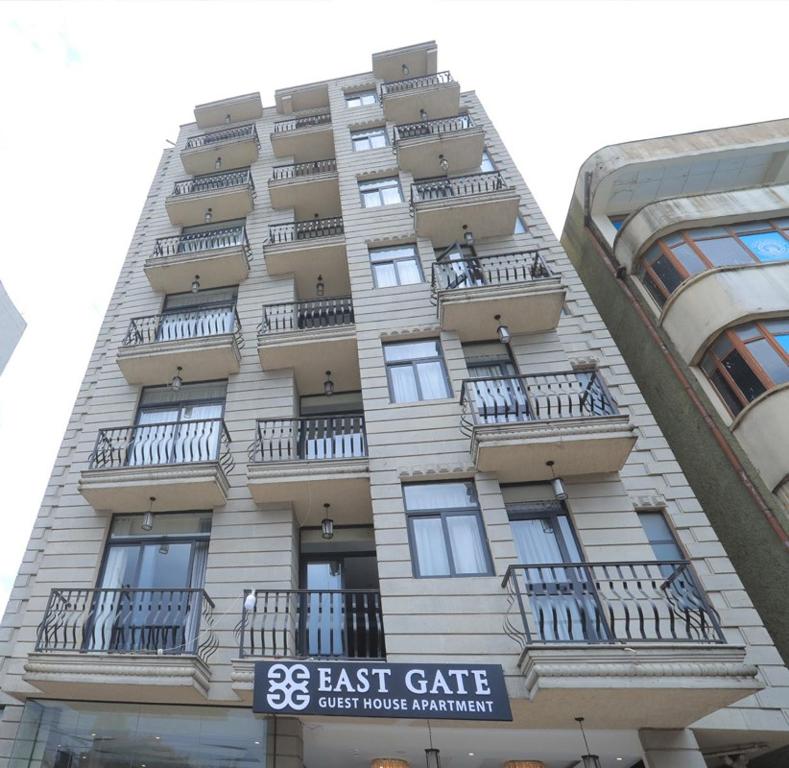 un edificio alto con balcones a un lado. en East Gate Appartement Gust House en Addis Abeba