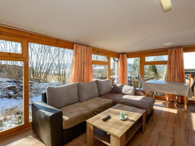 a living room with a couch and a table at Holiday home sunshine in Bad Koetzting