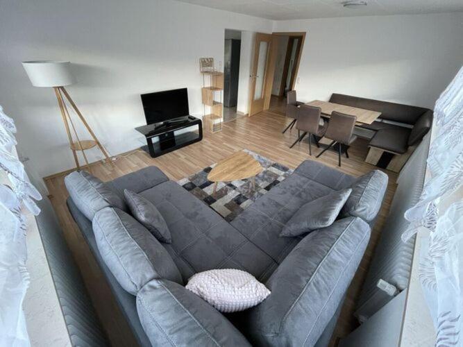 a living room with a couch and a dining room at Holiday apartment Talblick in Unterlenningen