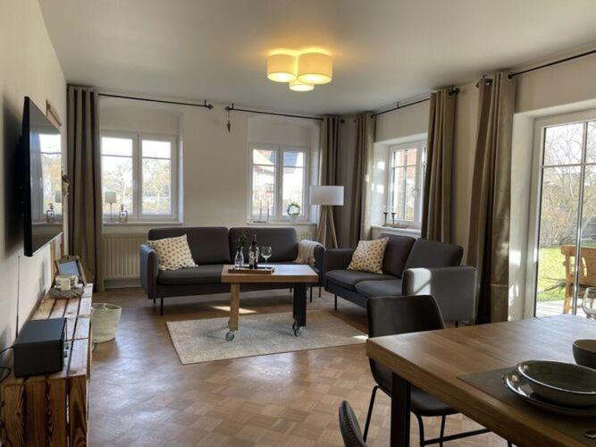 a living room with a couch and a table at Holiday apartment Landzauber in Heideck