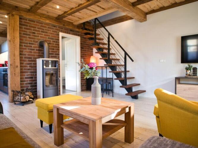 sala de estar con mesa y sillas amarillas en Baltic Sea Barn Otto, en Pantelitz
