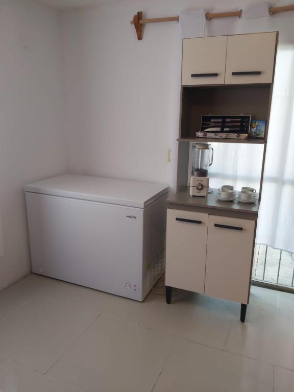 a white refrigerator in a room with a counter at LA TORRE in Manantiales