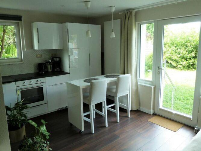 una cocina con mesa y sillas blancas. en Apartment Ankenbrand, en Randersacker